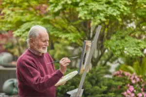 Brain Health resources. Older man painting outside.