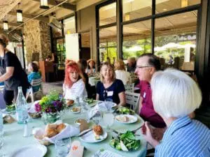Experience Corps Bay Area Volunteers at Recognition Event. Group of volunteers at table eating.