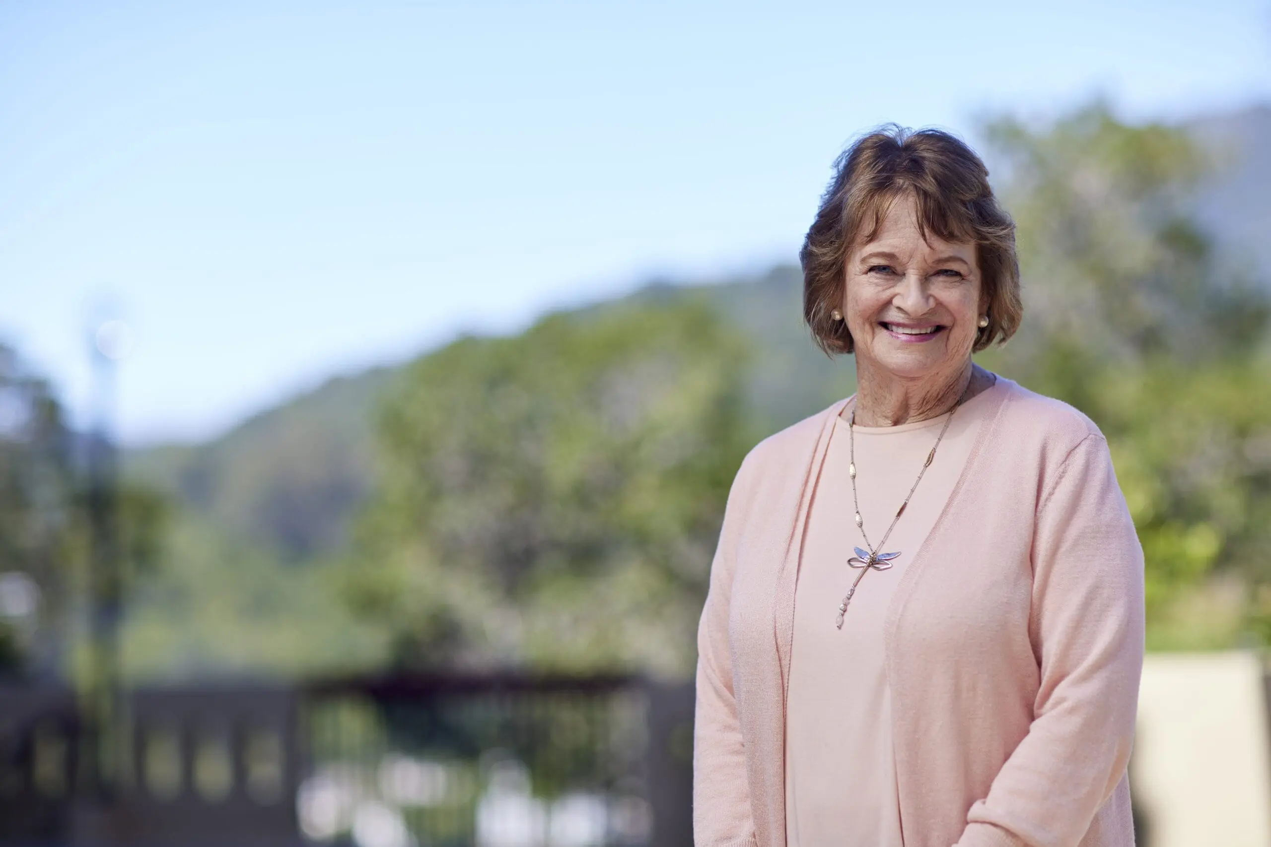 Female resident smiling, outdoors in community