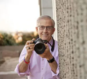 Community living | The Sequoias, San Francisco resident smiling holding a camera
