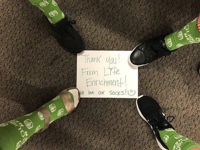 Sequoia Heroes socks with the sign "Thank you From Life Enrichment"
