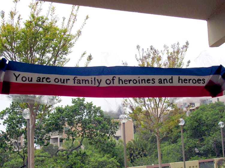 Sign reading "You are our family of heroines and heroes"