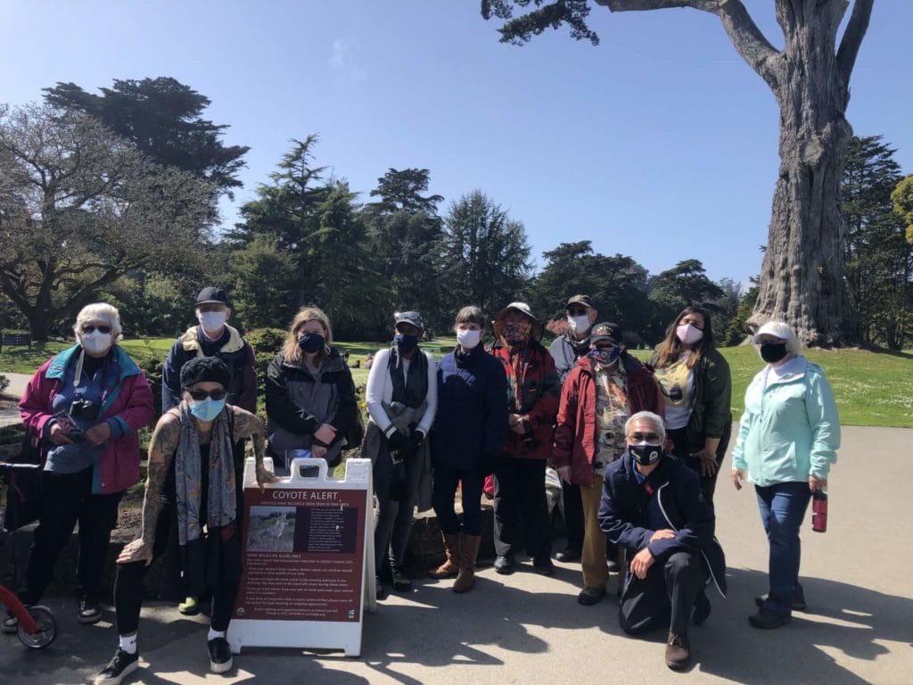 Members of San Francisco Senior Center's Plant Chat group standing together outside