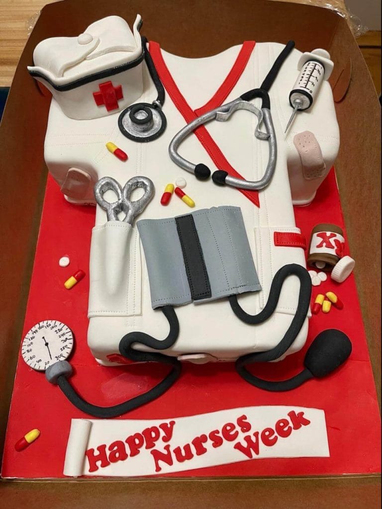 Cake decorated like a nurse's uniform. "Happy nurses week"