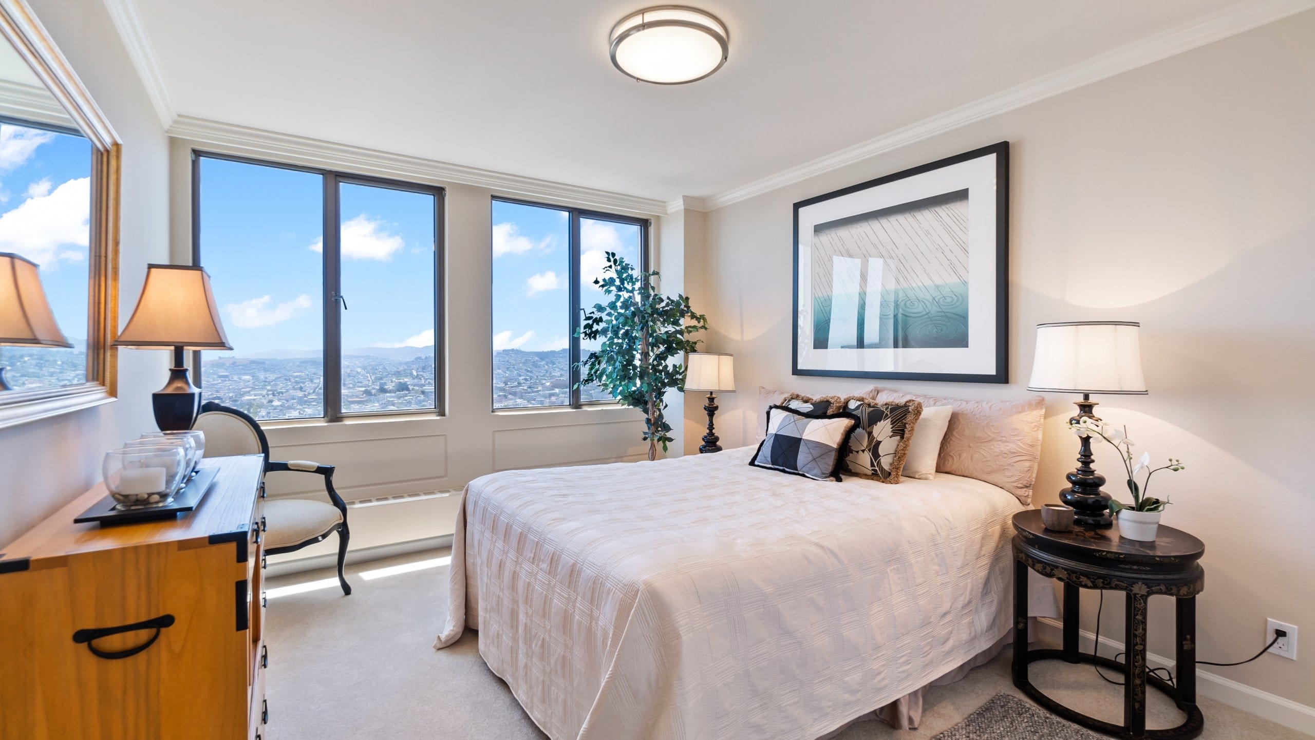 Interior photo of a furnished bedroom at the San Francisco Sequoia with a view of the city