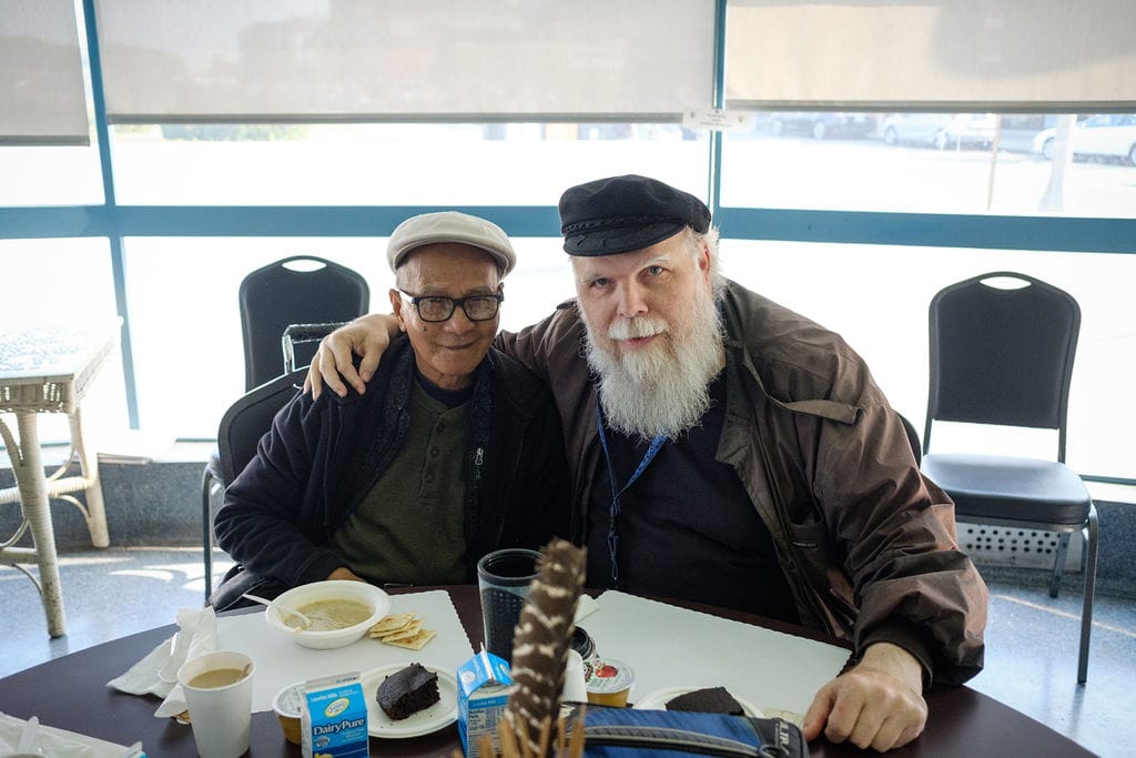 Two senior men enjoying lunch together