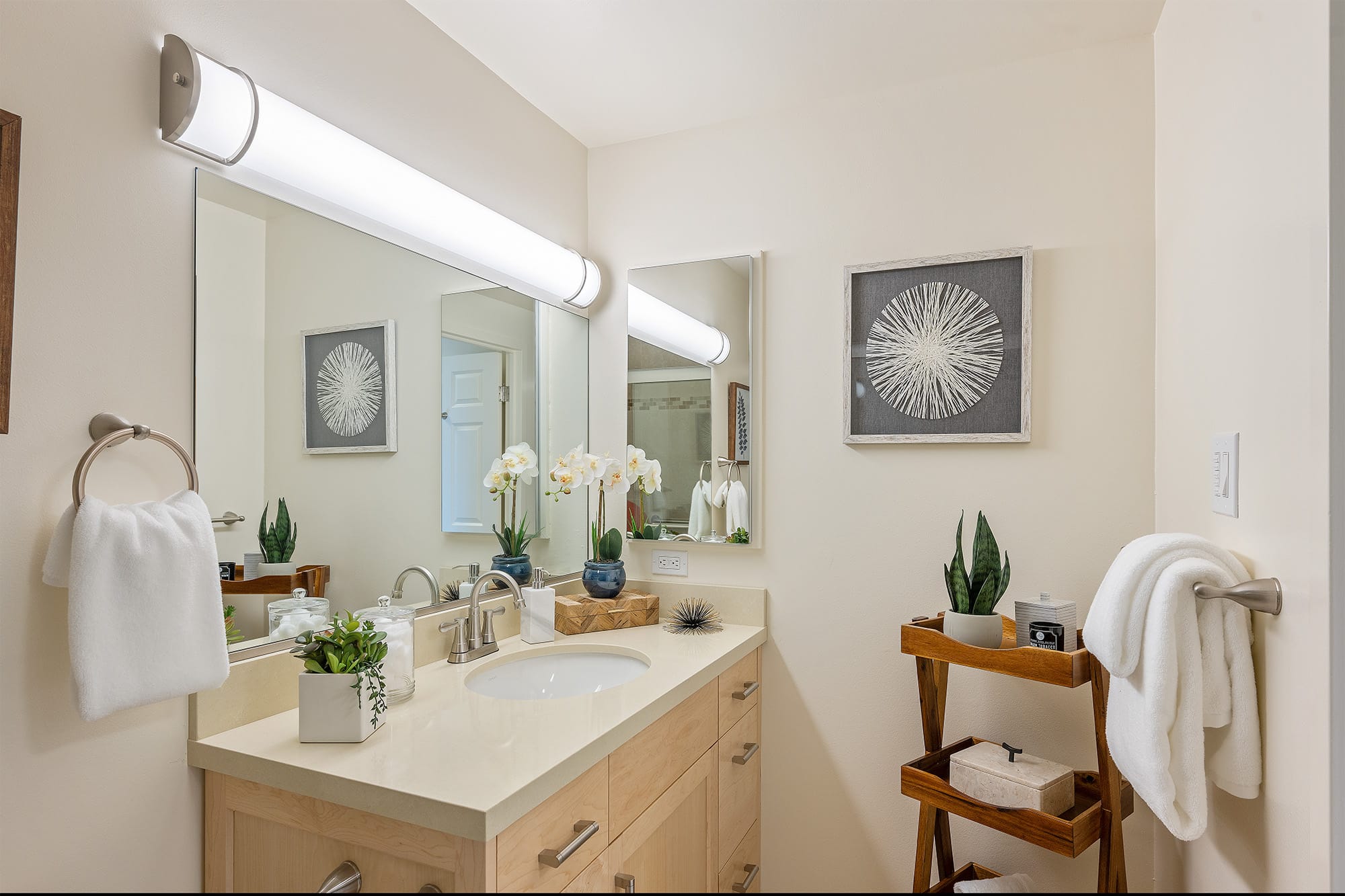 Bathroom in studio apartment with white walls and white countertop.