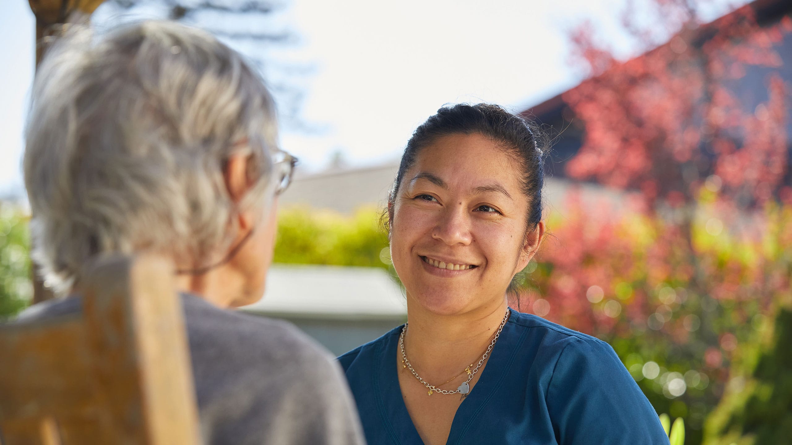 Skilled nursing, Caregiver chats with female resident