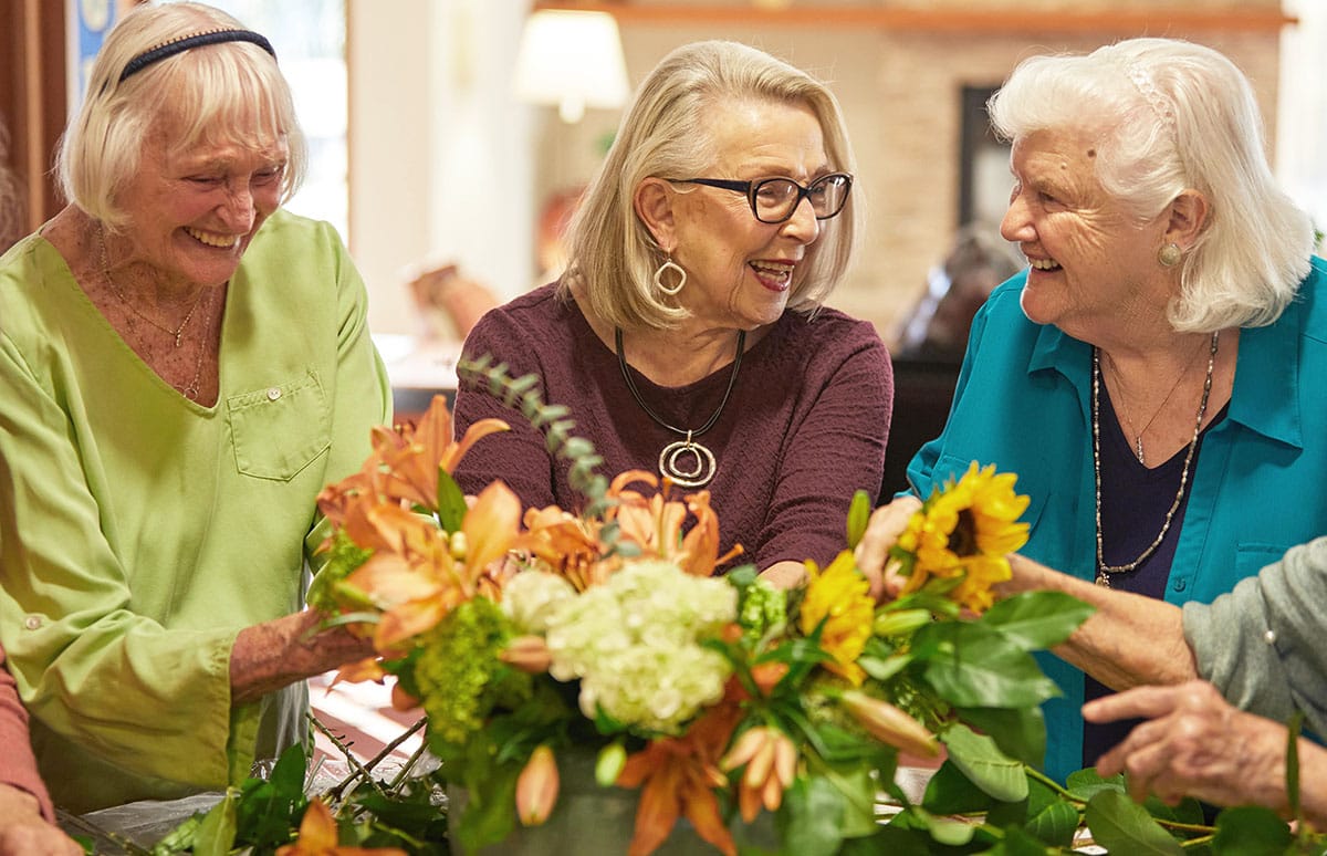 Committees, three female residents, arranging flowers, Life at Sequoia Living, Never Stop Growing