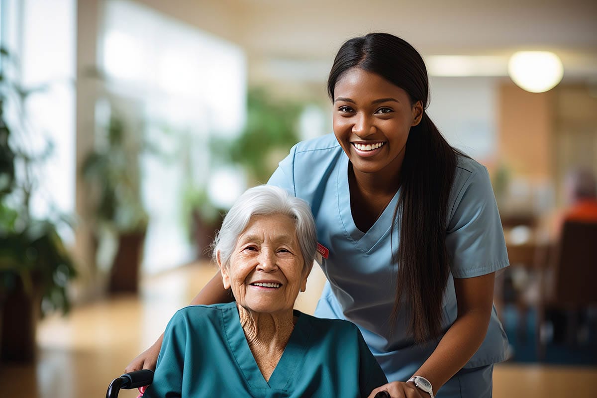 Senior woman and female caretaker smiling, nursing home, skilled nursing