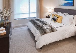 bedroom with grey blanket on bed