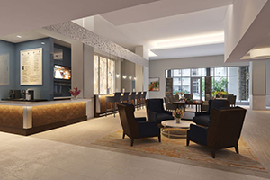 Viamonte lobby with brown lounge chairs, blue wall, white ceilings, and a coffee bar