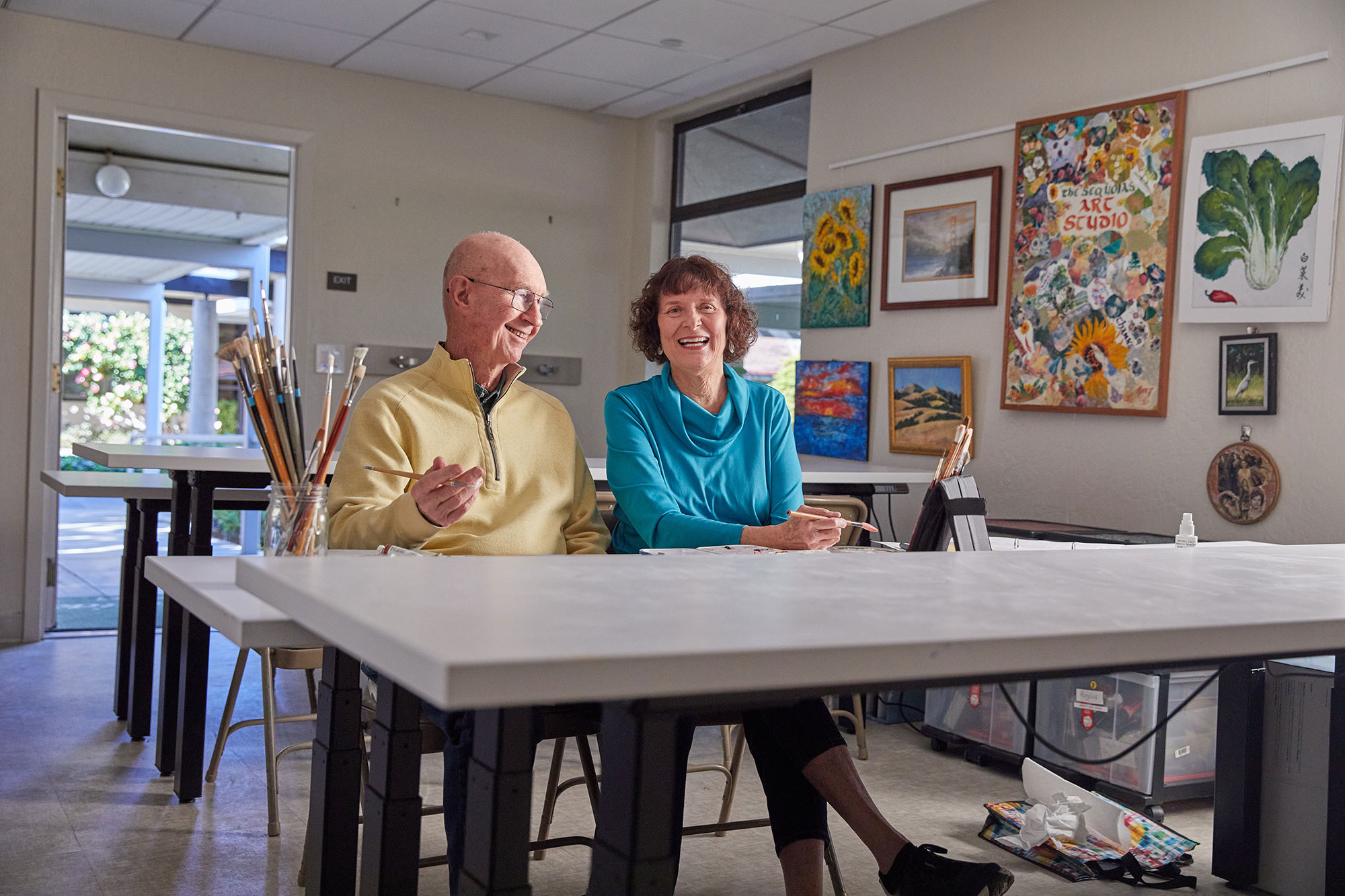 Two residents enjoying art projects at The Sequoias Portola Valley