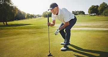elderly man playing golf