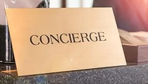 gold concierge sign on a counter top