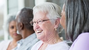 Elderly women talking and smiling