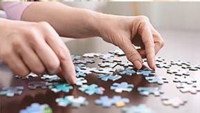 Person arranging puzzle pieces