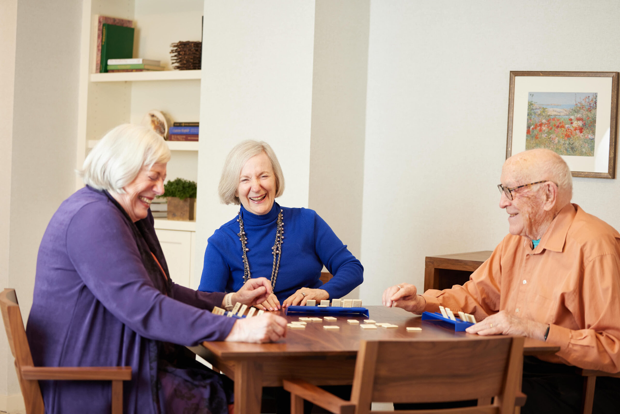 Elderly couple sitting around playing a board game