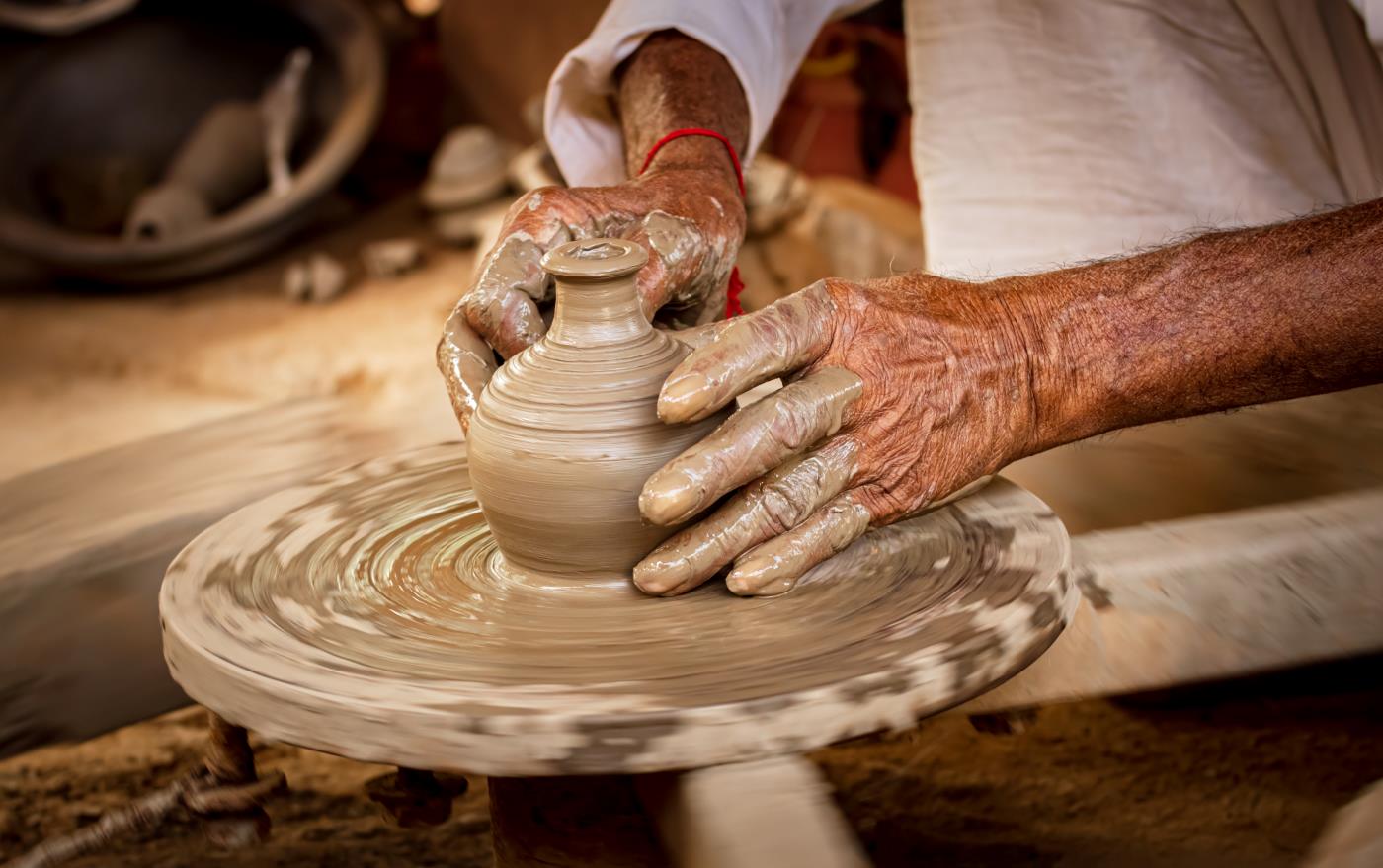 older adults hands doing pottery
