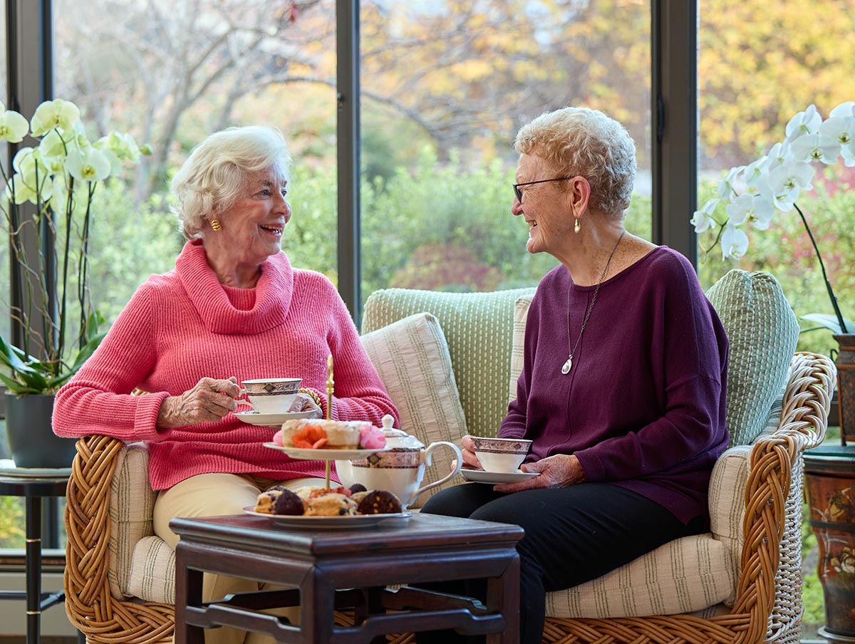 Lifestyle | The Sequoias Portola Valley, two female residents seated, having tea