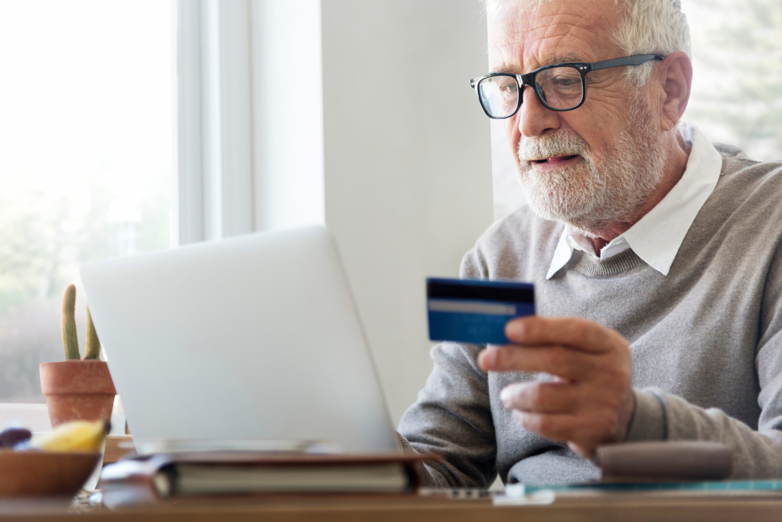 Man using credit card to purchase something online