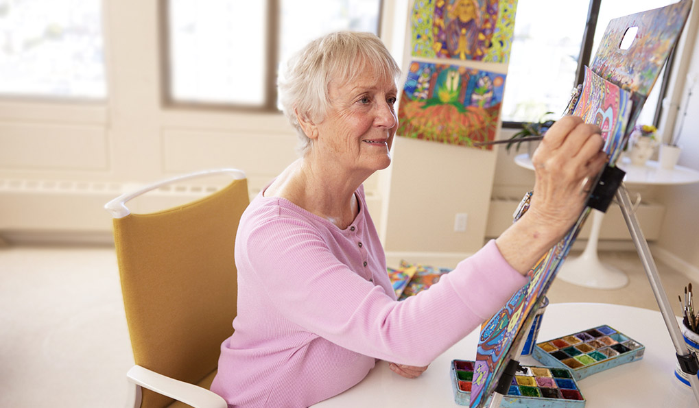 Independent Living Communities, Reignite Passions and Hobbies, artist, female resident, painting on easel in apartment at The Sequoias