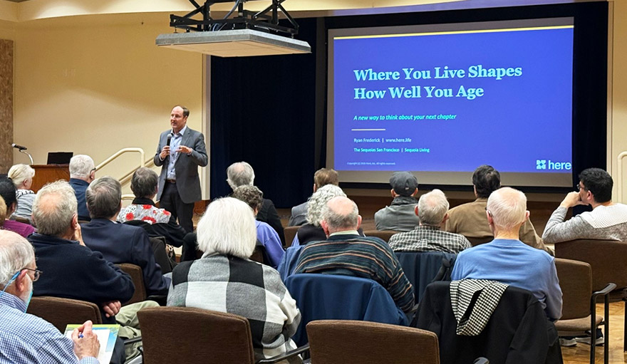 Lifelong Learning and Community | Ryan Frederick presentation, large group of audience, screen mentions "Where You Live Shapes How Well You Age"