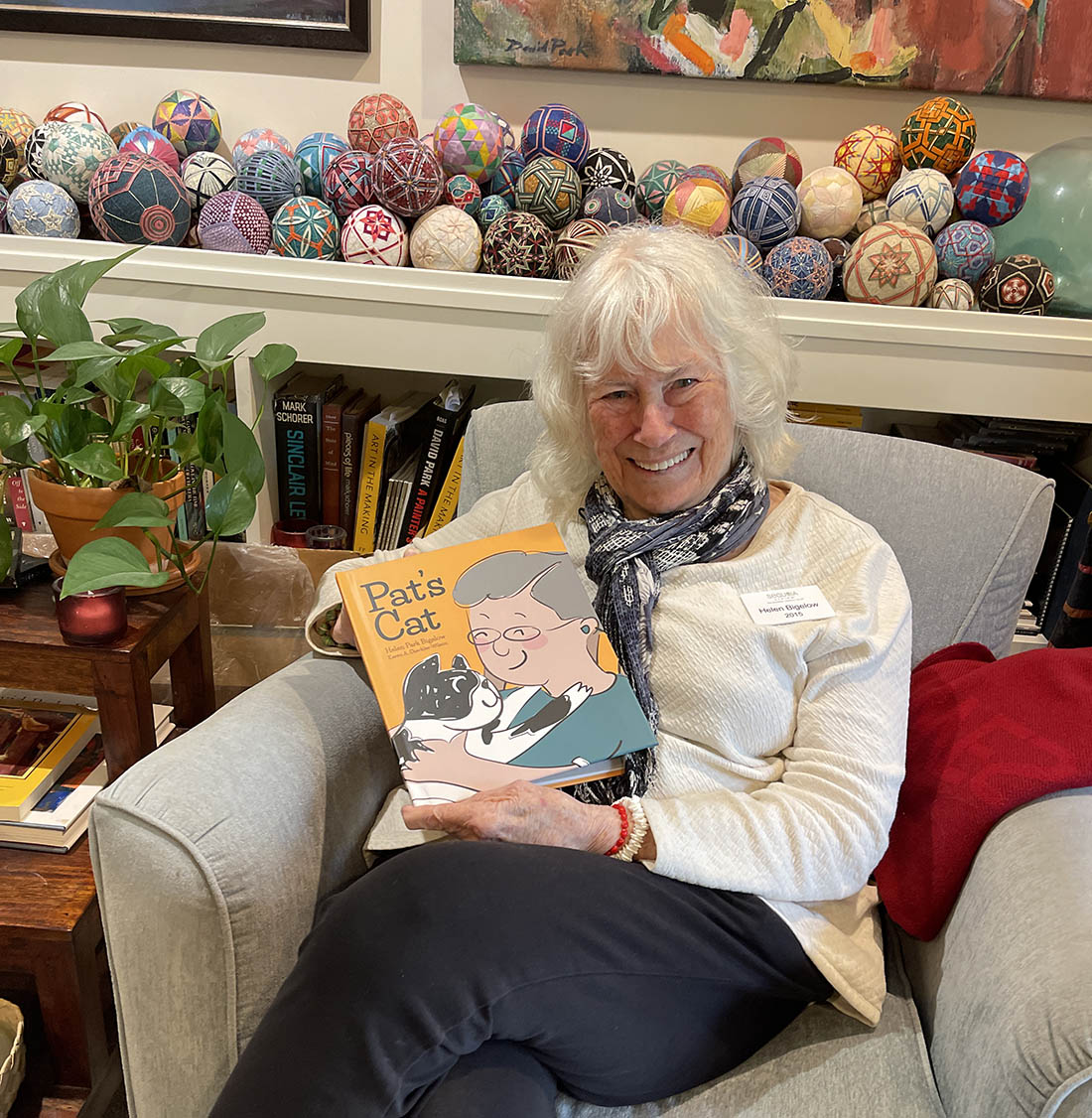 Never Stop Writing | Helen Resident, Sitting indoors in living room, holding Pat's Cat book