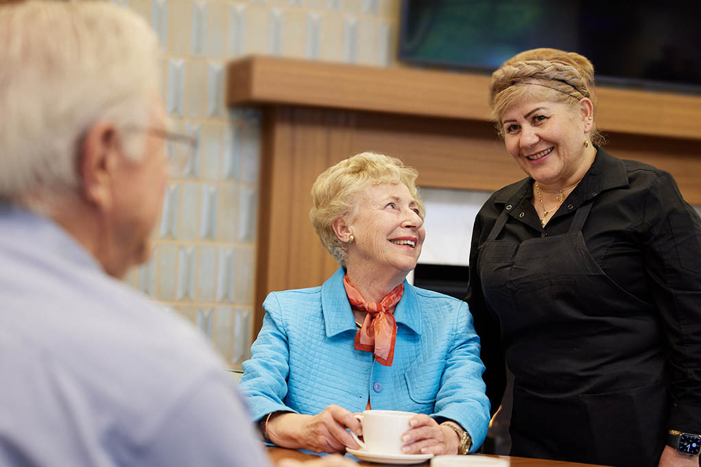 Intentional Senior Living Experience residents and team member | dining, at The Sequoias