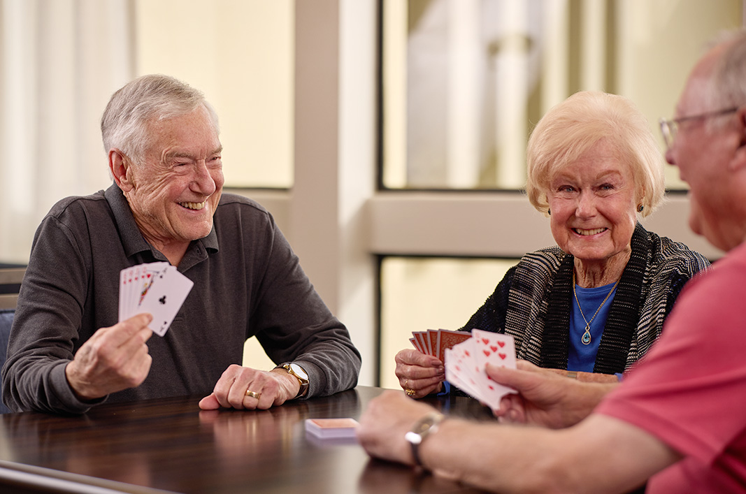 Benefits of retirement communities Sequoia Living Benefits of retirement communities | Sequoia Living, three happy residents sitting near window, playing cards
